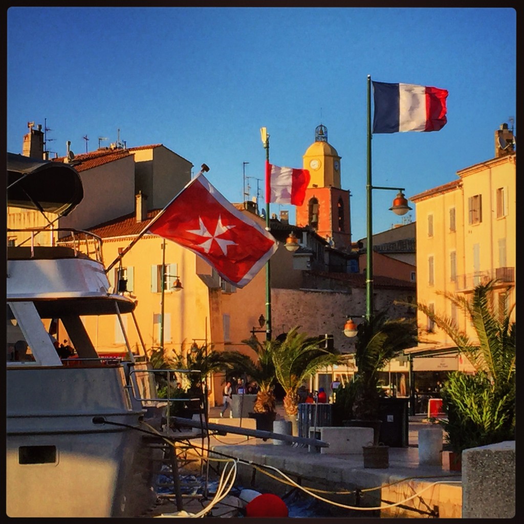 Vue sur les bateaux et le clocher rouge et jaune de Saint-Tropez 